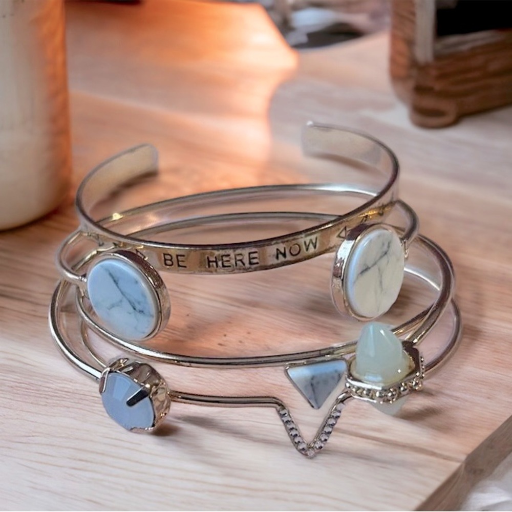 4 cute gold bracelets.